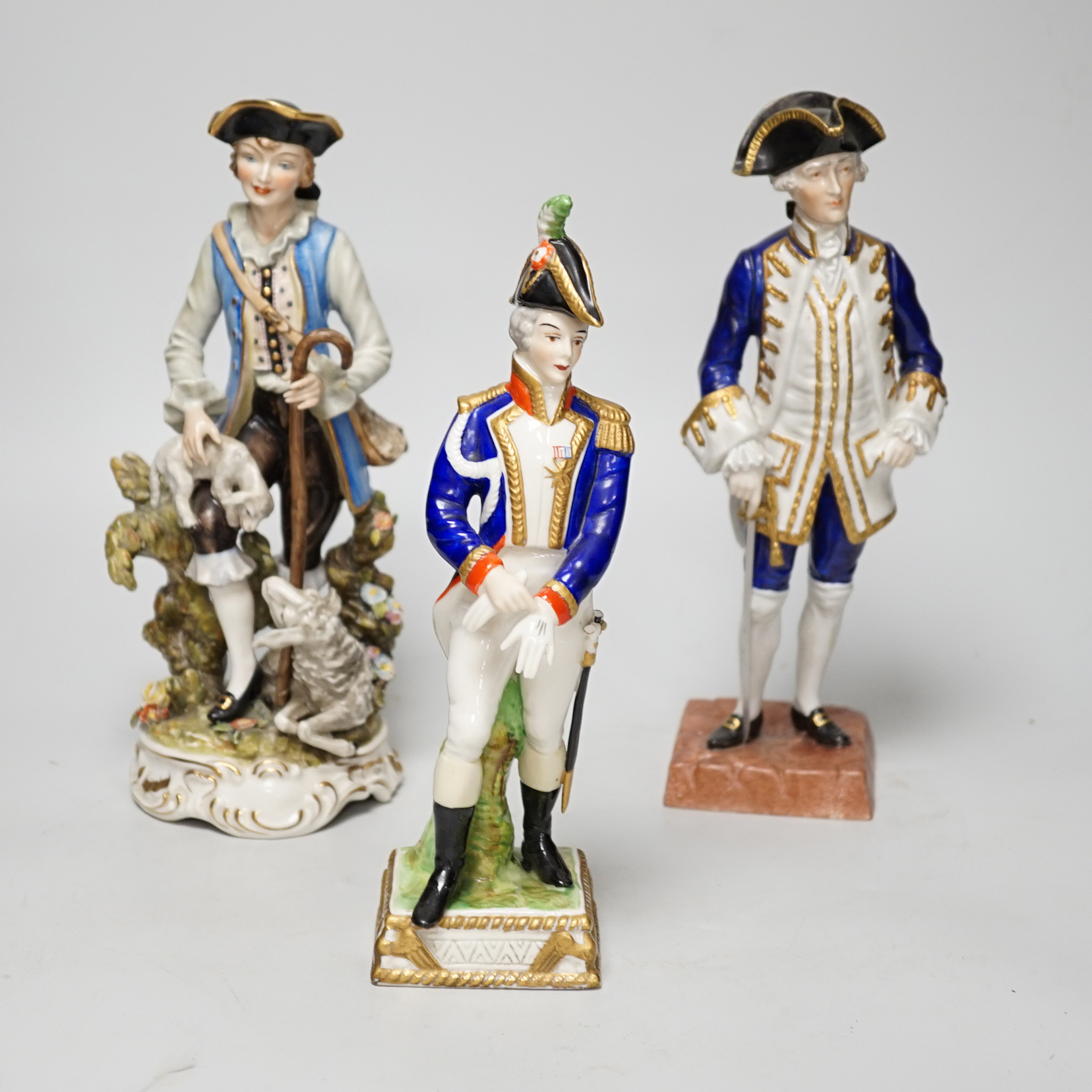 Two Dresden figure groups comprising a Shepherd and Admiral, together with one other, the largest 26cm high (3)